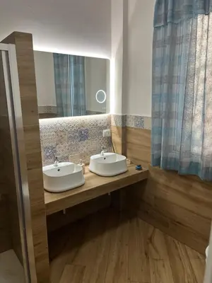 a bathroom with two sinks and a mirror at Sweetpalermo in Palermo