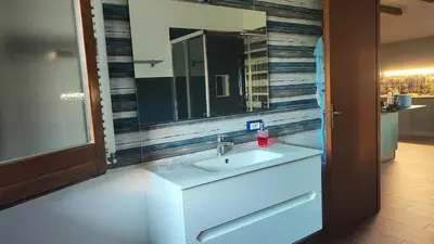 a bathroom with a sink and a mirror at Villa Betta Cuntrariusa con piscina privata e jacuzzi a Scopello in Castellammare del Golfo
