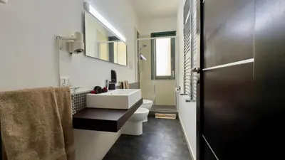 a bathroom with a white sink and a toilet at B&B Alla Stazione in Palermo