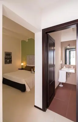 a hotel room with a bed and a sink at B&B Alla Stazione in Palermo