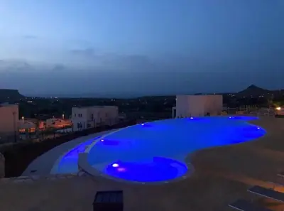 a large blue swimming pool at night at Giardino degli Allori, Villa Manfredi with Pool in Castellammare del Golfo