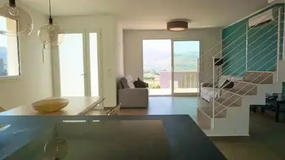 a living room with a couch and a table at Giardino degli Allori, Villa Manfredi with Pool in Castellammare del Golfo