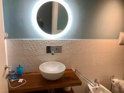 a bathroom with a white sink and a mirror at Giardino degli Allori, Villa Manfredi with Pool in Castellammare del Golfo