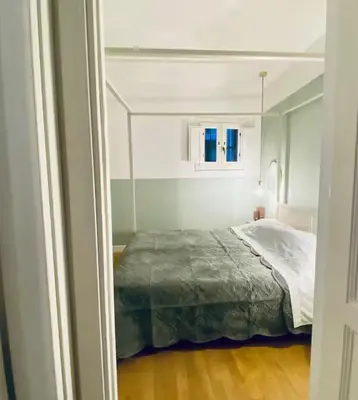 a bedroom with a bed in a white room at Tarzana’ home in Palermo