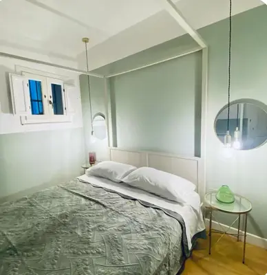 a bedroom with a bed and a glass table at Tarzana’ home in Palermo