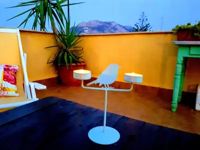 a white bird sitting on a chair in a room at Casetta Tiffany Mondello in Mondello