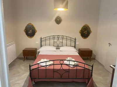 a bedroom with a bed with a red bedspread at 4 Seasons in Altavilla Milicia