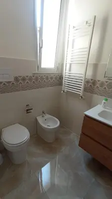a bathroom with a toilet and a bidet and a sink at 4 Seasons in Altavilla Milicia