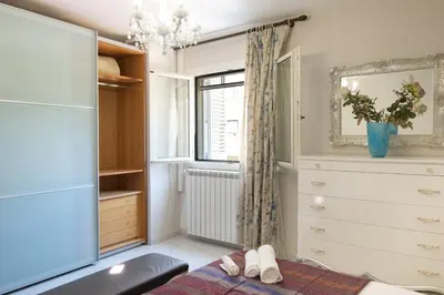 a bedroom with a dresser and a window at Appartamento centrale 2 camere a Termini Imerese - Marconi House in Termini Imerese