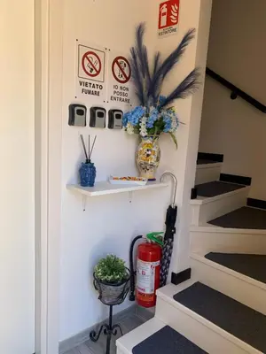 a hallway with stairs with a shelf and plants at U muragghiuni n3 in Lascari