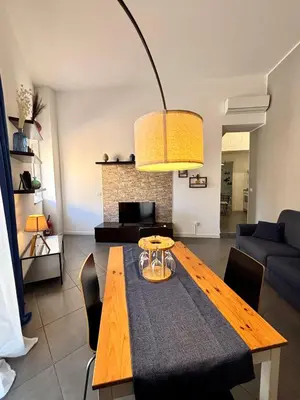 a dining room with a table and a couch at Dimora Al-Noor in Palermo
