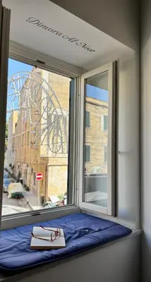 a window seat with a view of a street at Dimora Al-Noor in Palermo