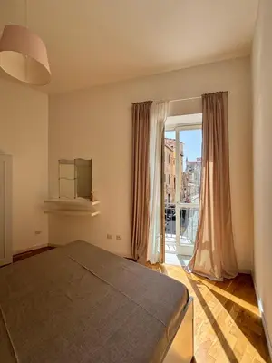 a bedroom with a bed and a large window at Dimora Al-Noor in Palermo