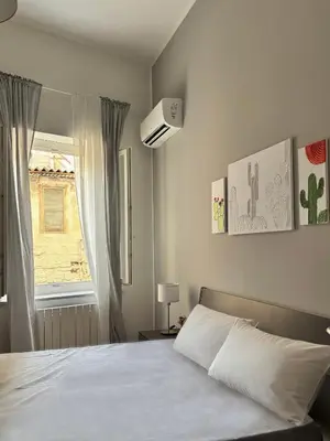 a bedroom with a white bed and a window at Dimora Al-Noor in Palermo