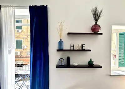 a room with shelves with vases and a window at Dimora Al-Noor in Palermo