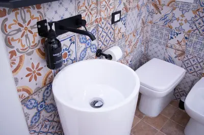 a bathroom with a white sink and a toilet at San Carlo Cuore di Palermo in Palermo