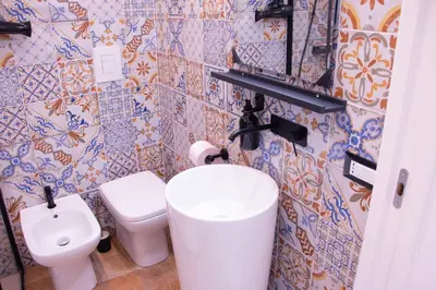 a bathroom with a toilet and a sink at San Carlo Cuore di Palermo in Palermo