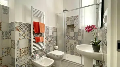 a bathroom with a toilet and a sink at Chez D'Ossuna con Patio Privato - centro storico Cattedrale - ampio 6 ospiti in Palermo