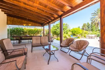 an outdoor patio with chairs and a table and a tablektop at Villa Deluxe in Campofelice di Roccella