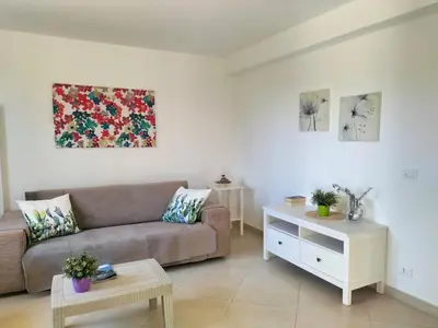 a living room with a couch and a table at Villa Deluxe in Campofelice di Roccella