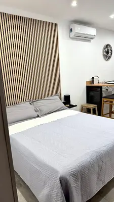 a bedroom with a white bed and a desk at DiGi Home in Palermo