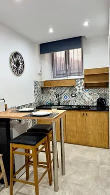 a kitchen with a sink and a table with chairs at DiGi Home in Palermo