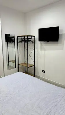 a bedroom with a bed and a flat screen tv at DiGi Home in Palermo
