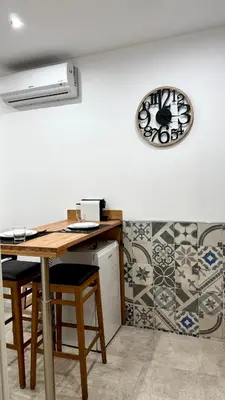 a kitchen with a table and a clock on the wall at DiGi Home in Palermo