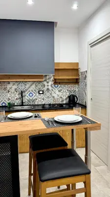 a kitchen with a counter with two plates on it at DiGi Home in Palermo