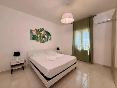 a white bedroom with a bed and a window at Villa GioEle - Pool & Relax in Mandra Capreria