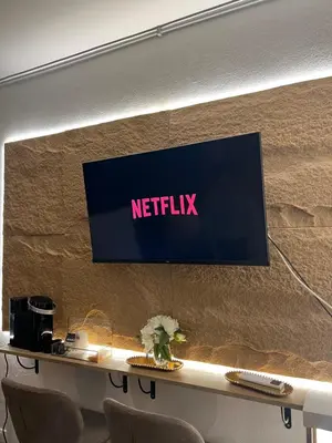 a sign on a wall with a netflix sign on it at Armonia Serenity Room Politeama in Palermo