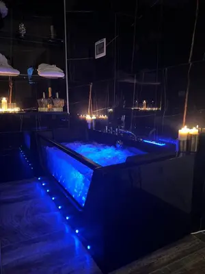 a hot tub in a room with blue lights at Armonia Serenity Room Politeama in Palermo