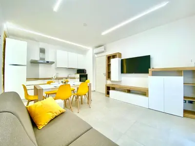 a kitchen and living room with a couch and a table at Appart Perla, posizione strategica in Castellammare del Golfo
