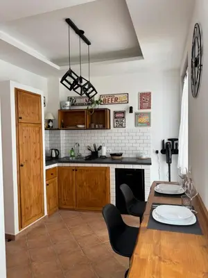 a kitchen with a table and chairs in a room at Domus Vucciria in Palermo