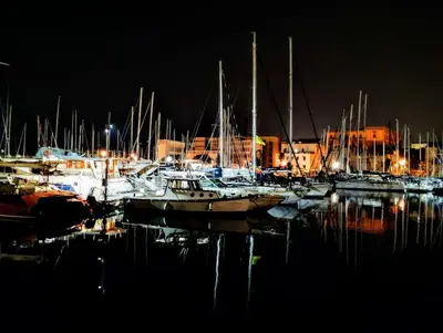 a group of boats docked in a harbor at night at Domus Vucciria in Palermo
