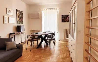 a living room with a table and chairs and a couch at Maison S Elena in Palermo