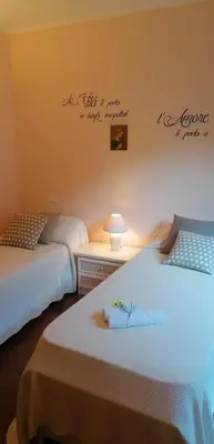 a bedroom with a bed with a blue comforter at Villa Angel in Mandra Capreria