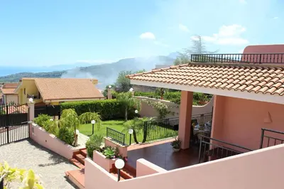 a table with a plate of food and glasses of wine at Villa Angel in Mandra Capreria
