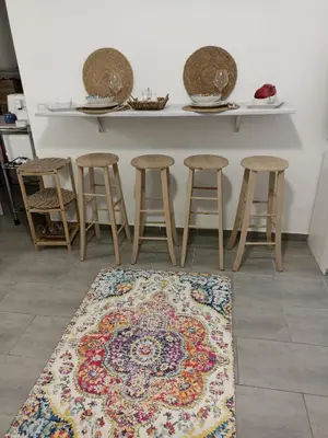 a kitchen with a table with stools and a rug at Naima House in Palermo