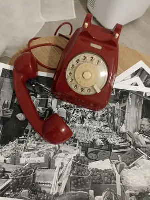 a red phone sitting on top of a table at Naima House in Palermo