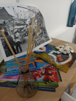 a glass vase with sticks in it on a table at Naima House in Palermo