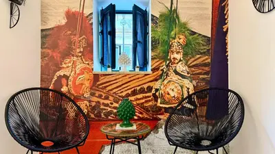 two chairs and a table in front of a window at I Paladini ORLANDO Apartment in Palermo