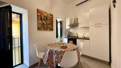 a kitchen with a table and chairs in a room at I Paladini ORLANDO Apartment in Palermo