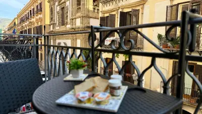 a table with a tray of food on a balcony at I Paladini ORLANDO Apartment in Palermo