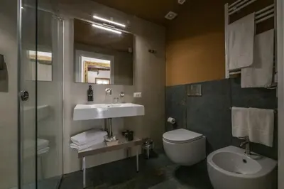 a bathroom with a sink and a toilet and a mirror at Ballarooms Experience in Palermo