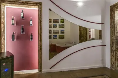 a bathroom with a pink wall with a staircase at Ballarooms Experience in Palermo