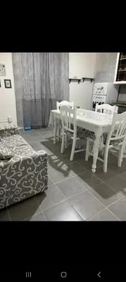 a dining room with a table and chairs and a bed at Casa Passamonte in Palermo
