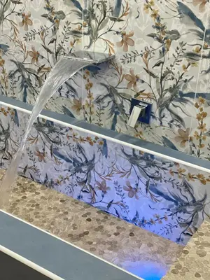 a bathroom with a blue and white floral wallpaper at Luxury Royal House in Palermo