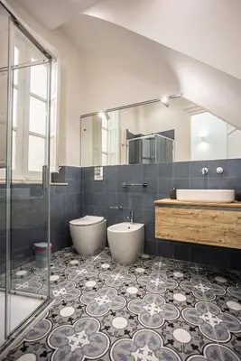a bathroom with two toilets and a tub and a mirror at Palermo Centro Le Cupole della Felicissima in Palermo
