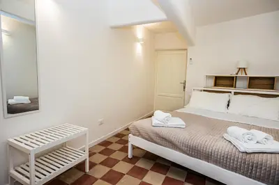 a bedroom with a bed with towels on it at Palermo Centro Le Cupole della Felicissima in Palermo